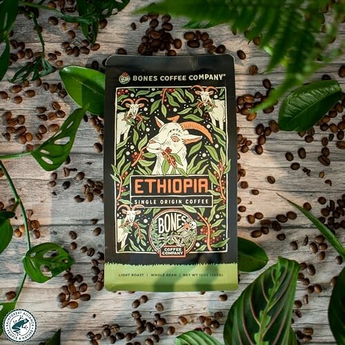 Ethiopia Single Origin Coffee package surrounded by coffee beans and leaves.